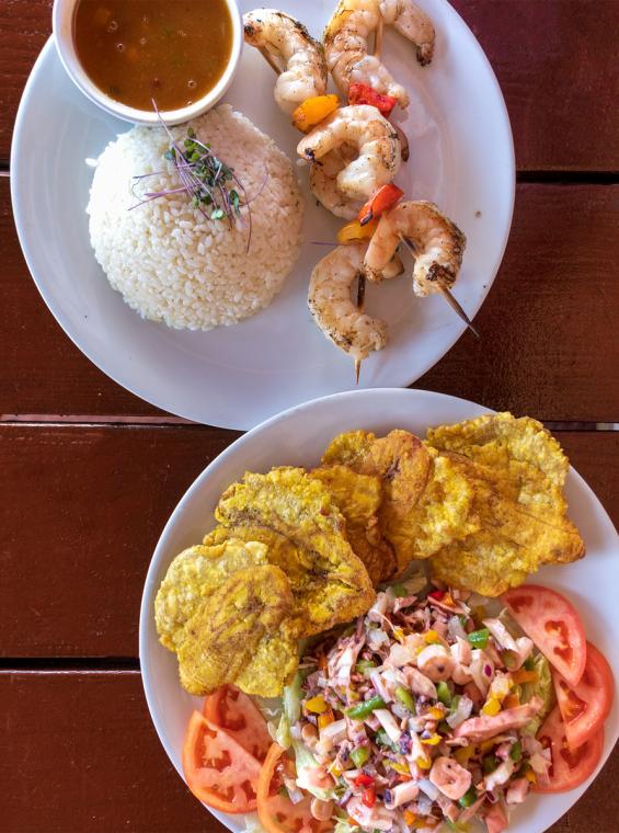 Plates of Puerto Rican food on a table viewed from overhead