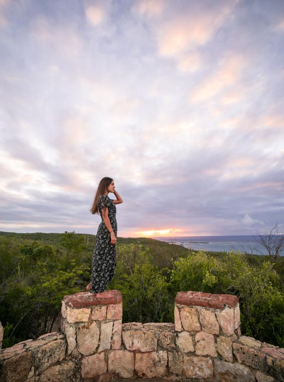 A woman stands at the top of Fuerte Capron, an historic fort inside Guanica Dry Forest.