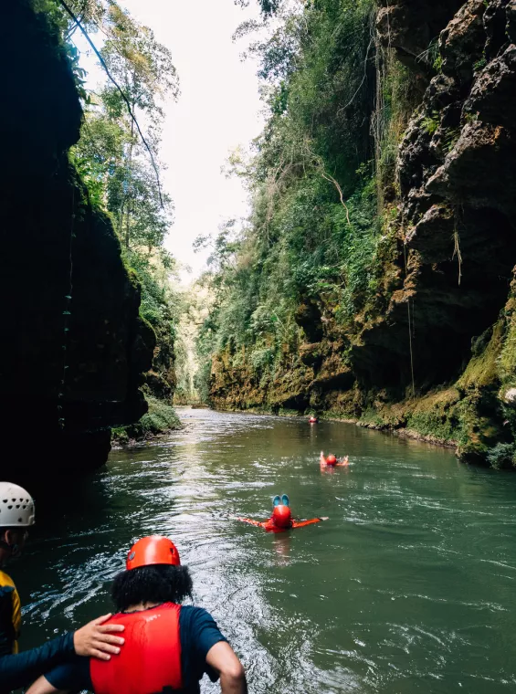 A group navigates the underground Tanama River in Utuado.