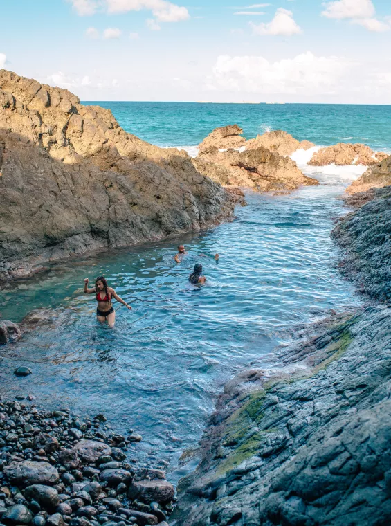 Hikers reaching La Zanja, a natural pool and hidden coastal trail in Fajardo, Puerto Rico.