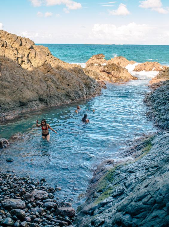 Hikers reaching La Zanja, a natural pool and hidden coastal trail in Fajardo, Puerto Rico.
