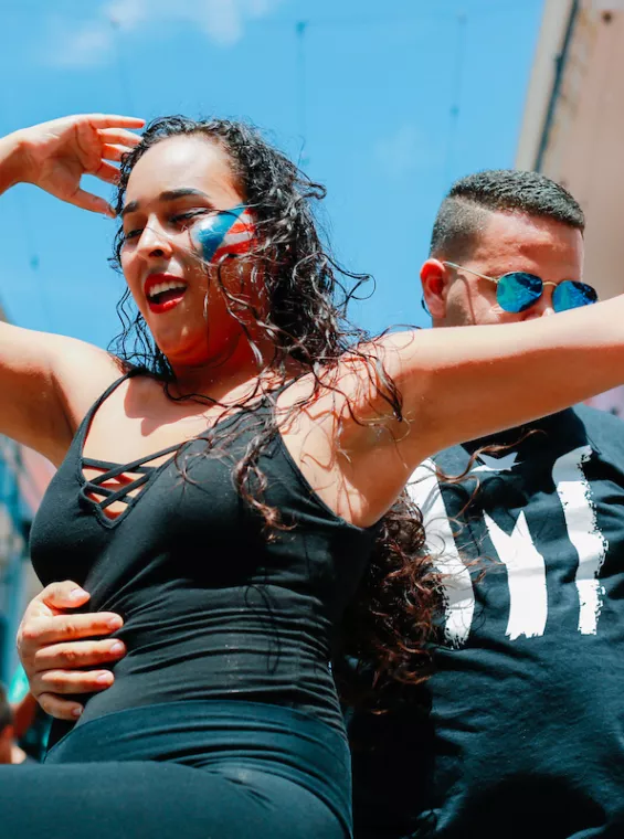 Pareja disfrutando del baile de salsa, género icónico originado en Puerto Rico.