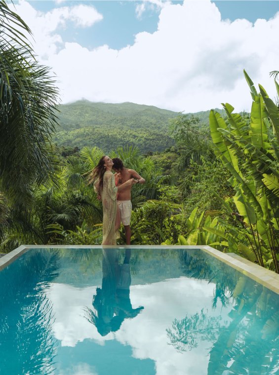 A couple embraces at the edge of an infinity pool in Rio Grande, Puerto Rico