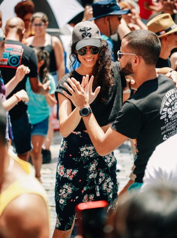 A group of people dancing salsa in the streets of Old San Juan, Puerto Rico.